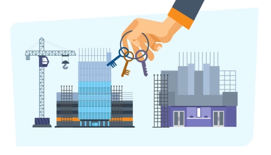 Commercial buildings under construction with a crane and framing materials visible, hand holding keys in front of previously described image